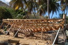 A new sloop takes shape under the palm trees