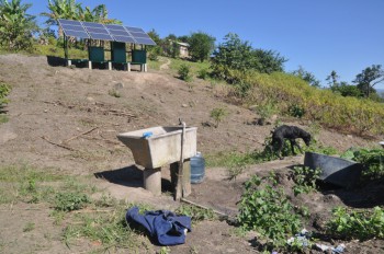 The laundry sink, the solar panels, and - in the background - the huts