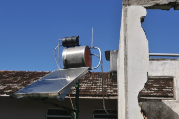 Solar water heater outside an abandoned house