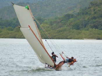 Teenagers racing their dad's canoe on the Rio Paraguaça, Bahia