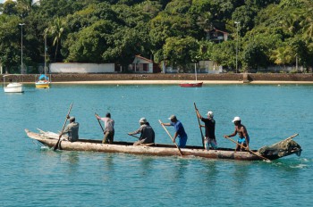 Fishermen in itaparica (Bahia) drive their canoe home with paddles