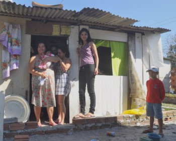 Catia and her family in the doorway of their house