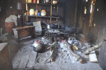 Catia's cook-house. Above the fire she hangs strips of fish which are smoke dried and thereby preserved.