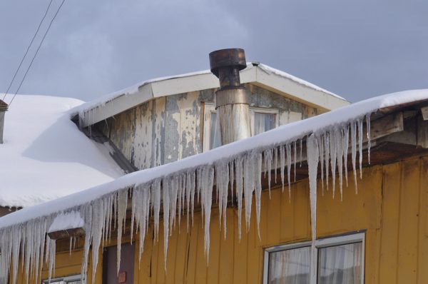 Icicles drip from the roof of a house in the centre of Puerto Williams